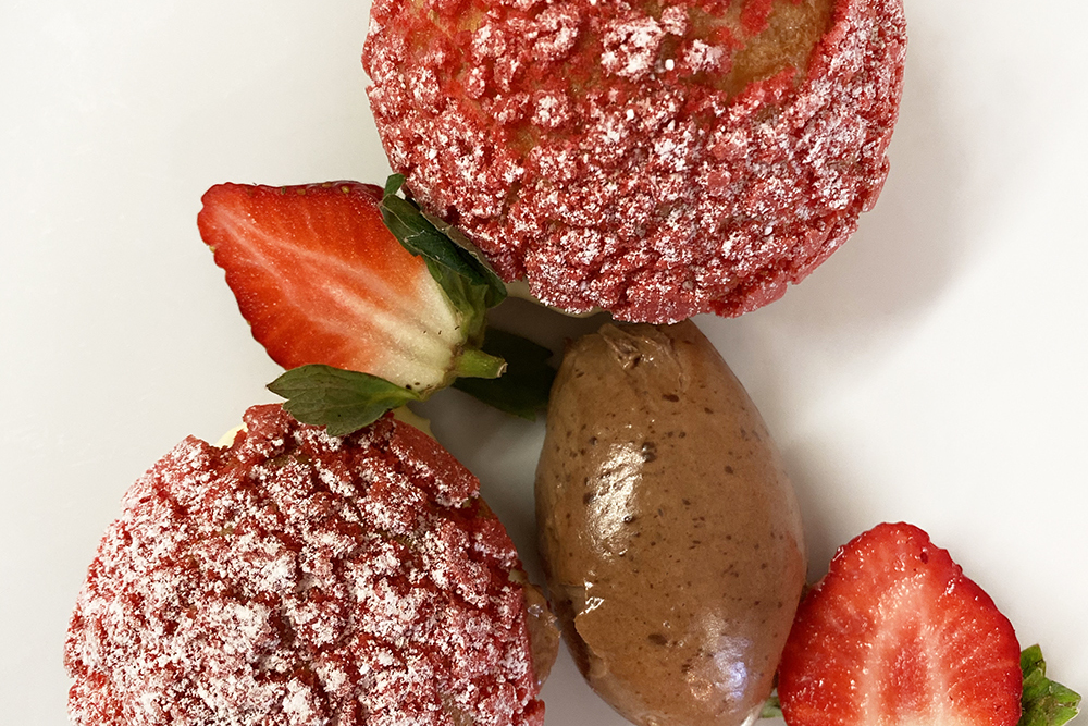 Macaroons, strawberries and a chocolate quenelle