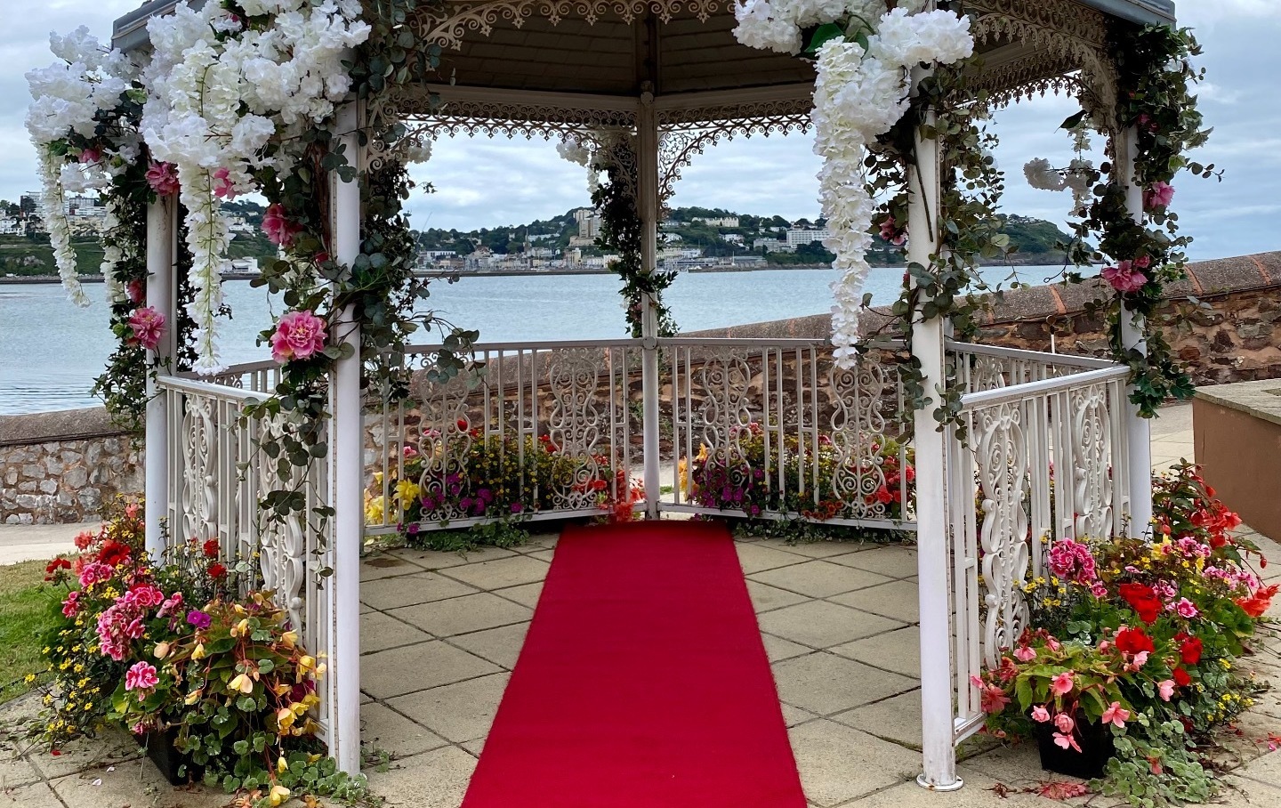 Wedding gazebo decorated in lots of flowers for a wedding ceremony